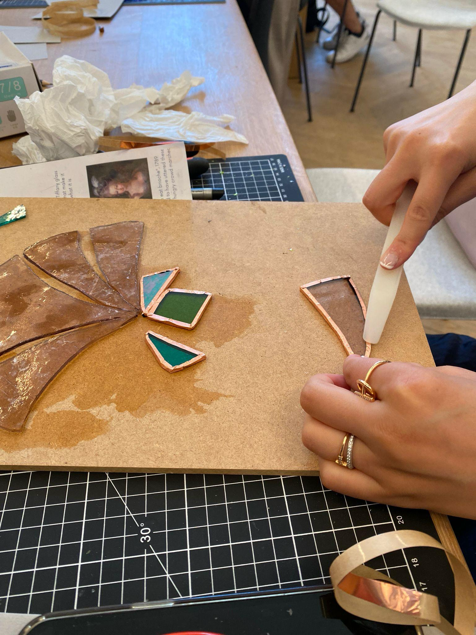 Burnishing copper foil on stained glass pieces